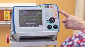 A hospital defibrillator. The same machine delivers both defibrillation and synchronized cardioversion — the synchronizer switch is what changes the mode.